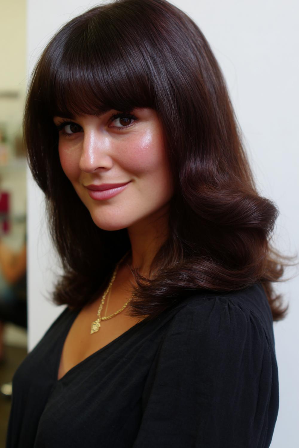 23. Side-Swept Bangs Hairstyle with Smooth Curve and Tucked Side