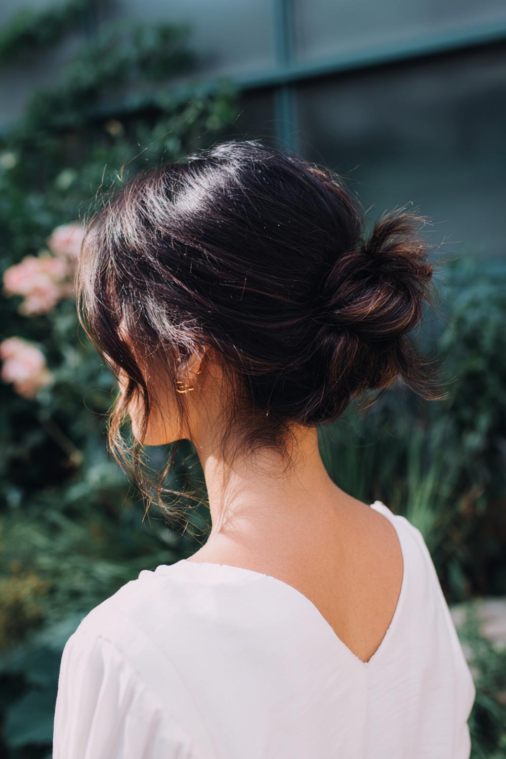 16. Hairstyles for All Hair Types: Messy Low Bun with Wispy Nape Pieces