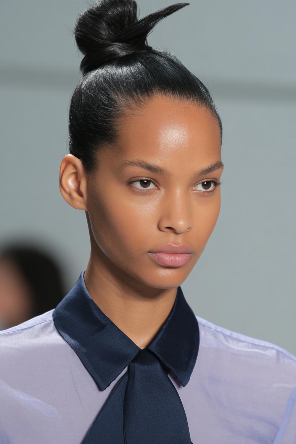 32. Hairstyles for All Hair Types: Sleek Top Knot with Sharp Part and Smooth Finish