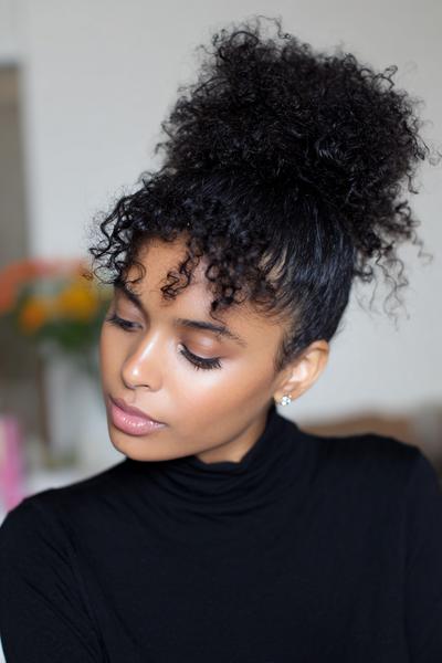 14. Sleek Low Bun with Curly Crown Puff for hairstyles for curly hair easy ideas