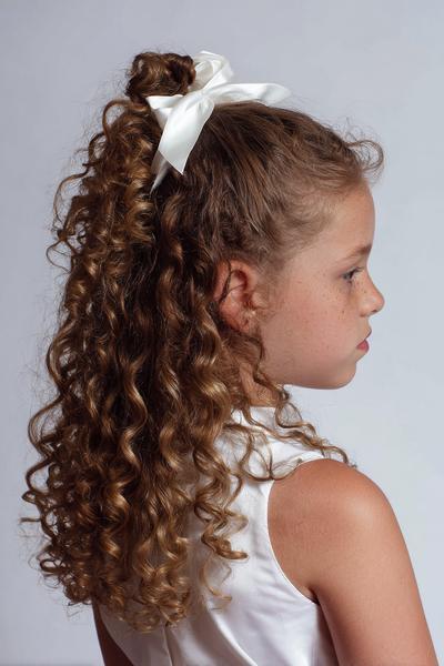 8. Half-Up Top Knot with Curly Ribbon Ends for hairstyles for curly hair kids ideas