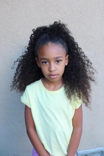 22. Defined Ringlet Half-Up Puff for hairstyles for kids curly hair ideas