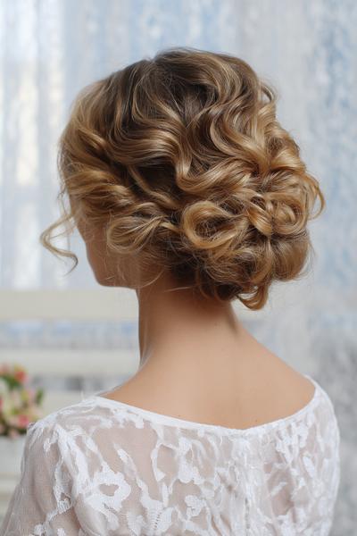 11. Curly Low Bun with Glossy Edges for hairstyles for medium length hair curly ideas