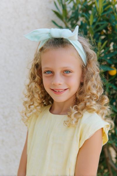 14. Curly Crown Headband Style for Hairstyles for School Curly Hair Kids with a Soft Bow Detail
