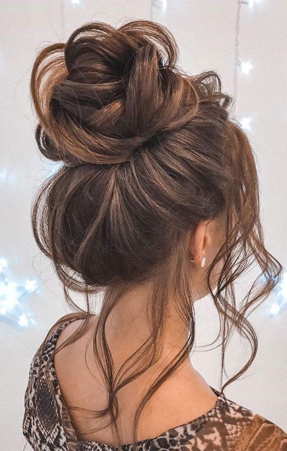 Voluminous messy high bun updo with lifted shape