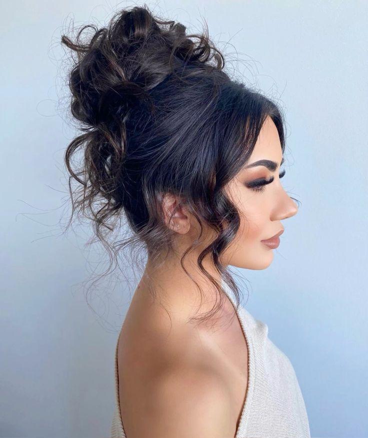 Polished messy high bun updo with elegant texture