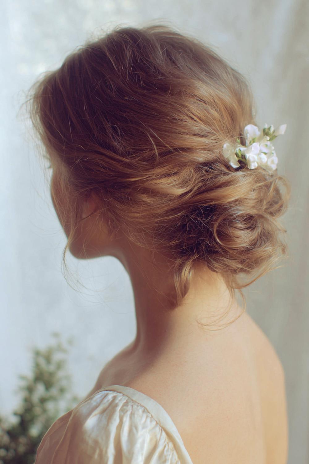 27. Simple Hairstyles for Long Hair: Low Side Bun With Romantic Loose Pieces